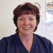 Sue Davies, lead dental therapist, smiles at the camera