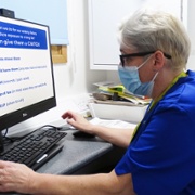 Debra at desk cropped.jpg