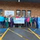 Fitness club members with cheque for chemo unit