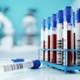 A stock image of  a few filled blood test tubes in a crate.