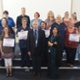 A group of patients and hospital staff, pictured with their certificates