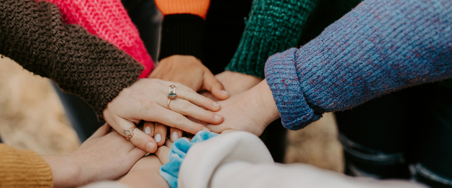 A group of people joining hands