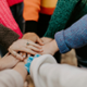 A group of people joining hands