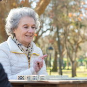 Older_lady_playing_dice_with_friends.png
