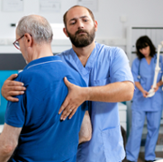 Male_physiotherapist_treating_patients_back.png
