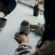 Two people sat at a table drinking coffee and chatting