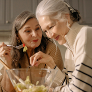 2_Ladies_eating_salad_in_kitchen.png