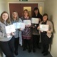 Some of the patient experience team holding up feedback on paper