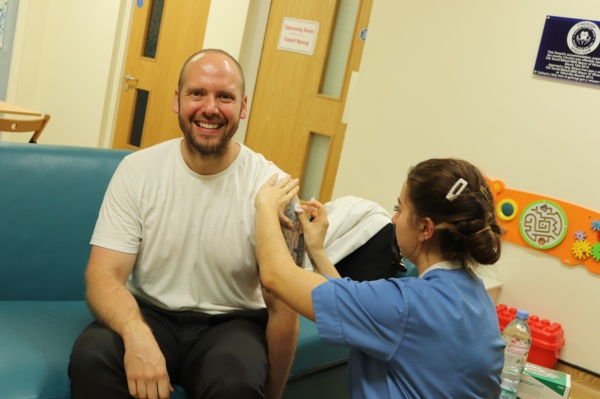 Patient receives flu vaccine from BCUHB nurse