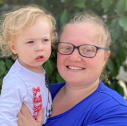 An image of peer supporter Amy holding her son