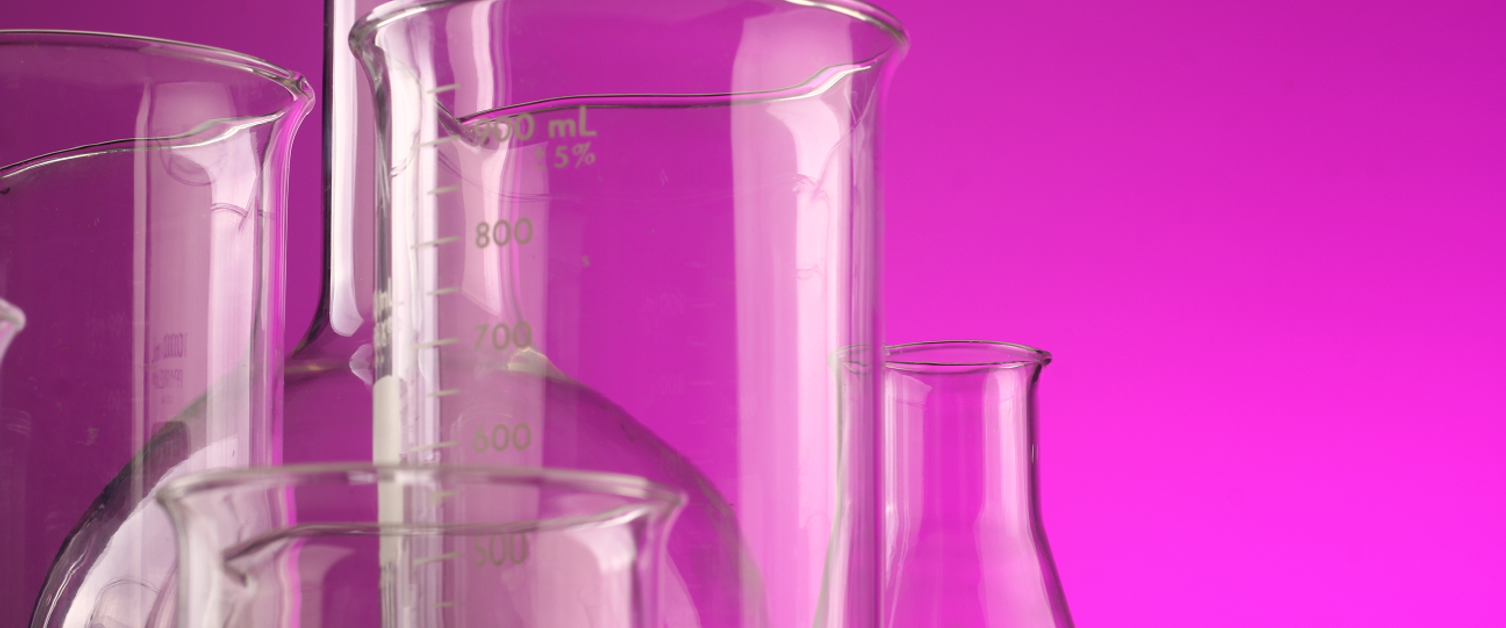 Laboratory glasses on a pink background