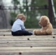 Picture of a baby and a teddy bear.