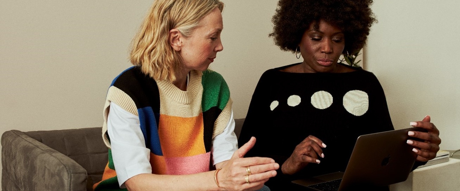 Two women discussing over an ipad