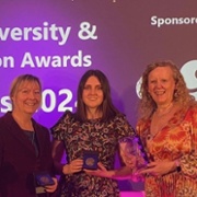 Jon, Katie, Lauren and Anne with awards - backdrop reads 