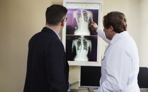 A doctor goes through an x-ray with a patient