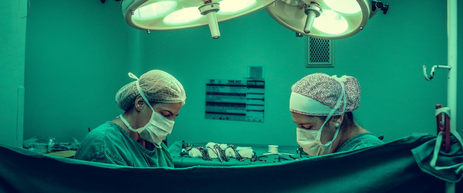 Two people performing a surgery