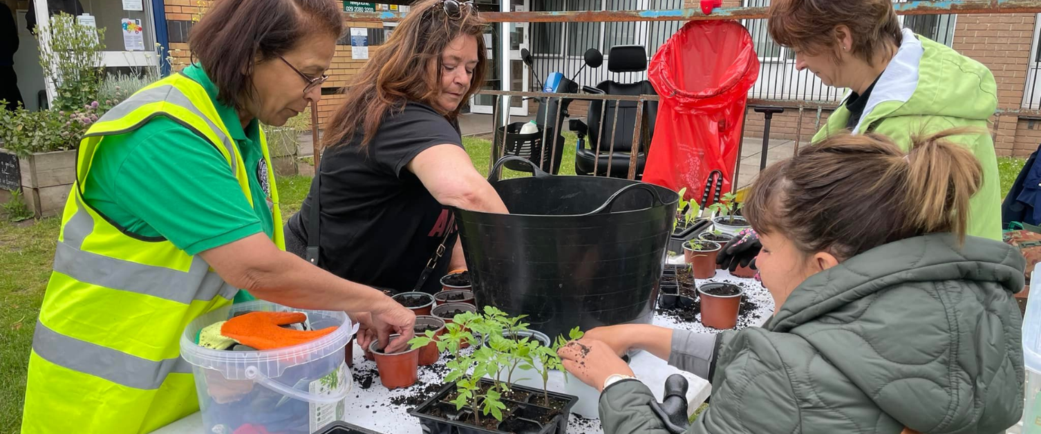 People planting at the at Riverside Health Centre community garden