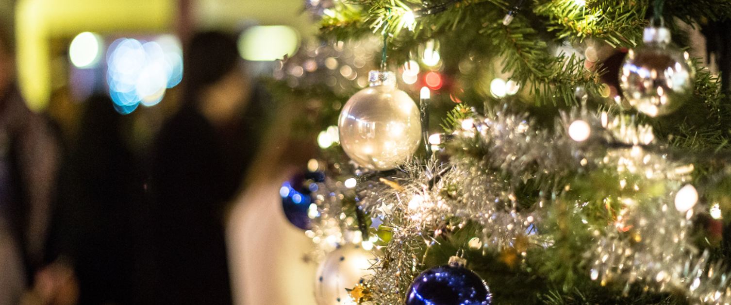 Close up image of Christmas tree decorated with baubles and tinsel