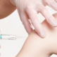 Hands applying vaccine