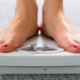 Image of someone standing on a weighing scale.