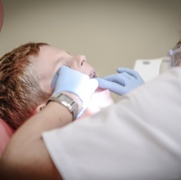 Canva - Dentist Woman Wearing White Gloves and White Scrubsuit Checking Boy's Teeth.jpg