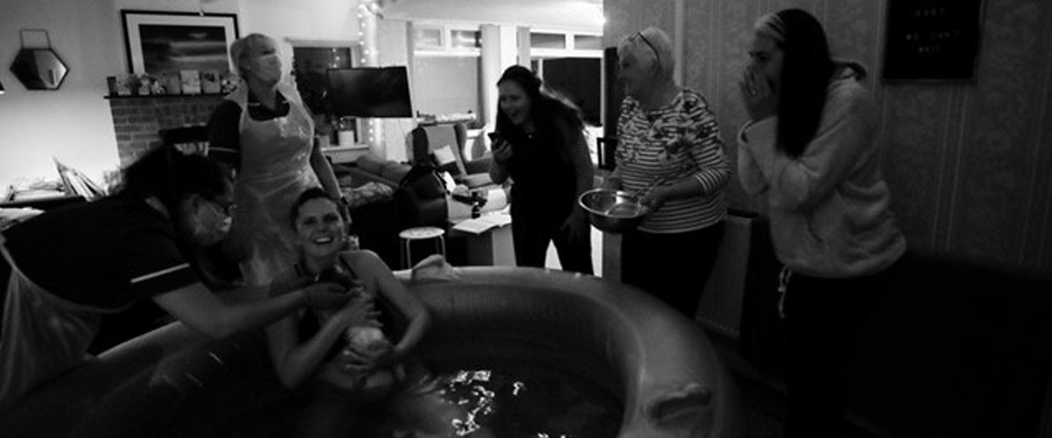 Group of women celebrating a water birth