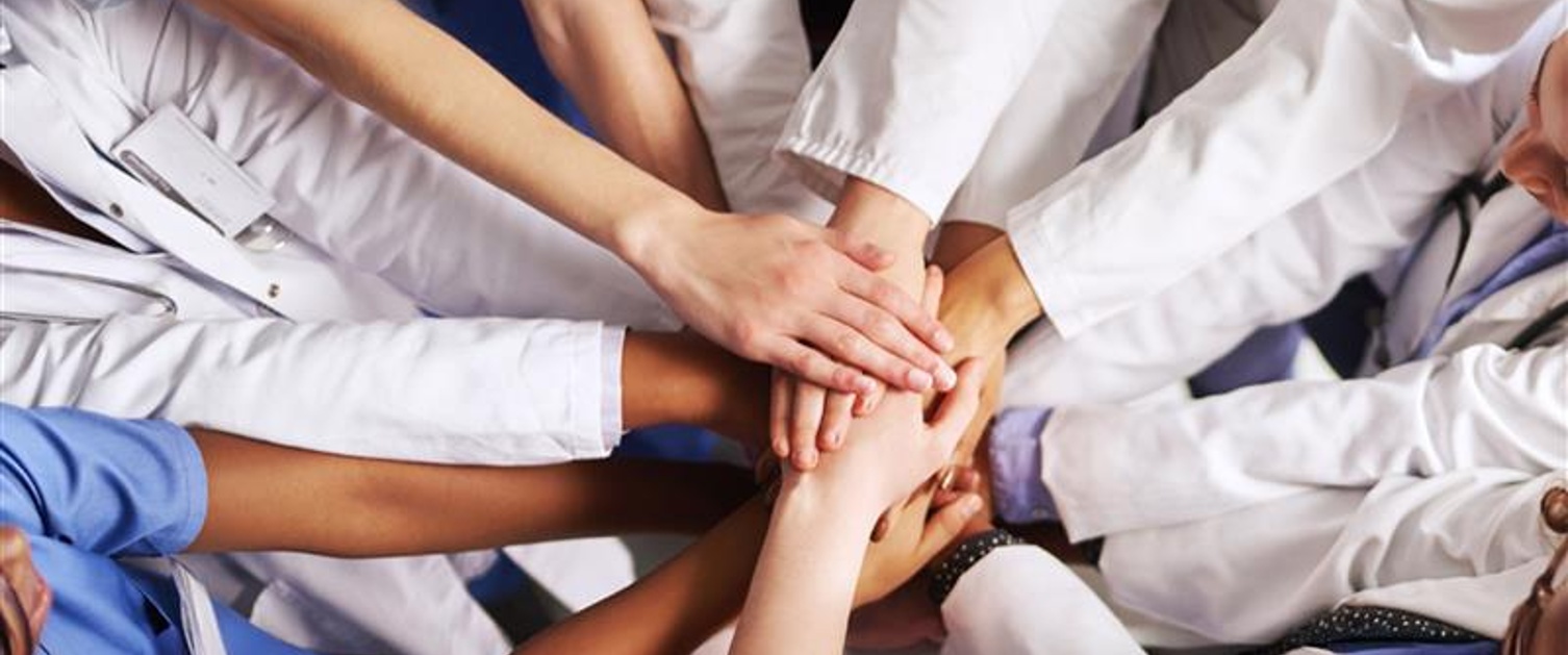 healthcare professionals joining hands