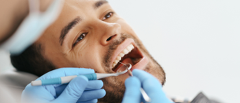 Dentist looking at man