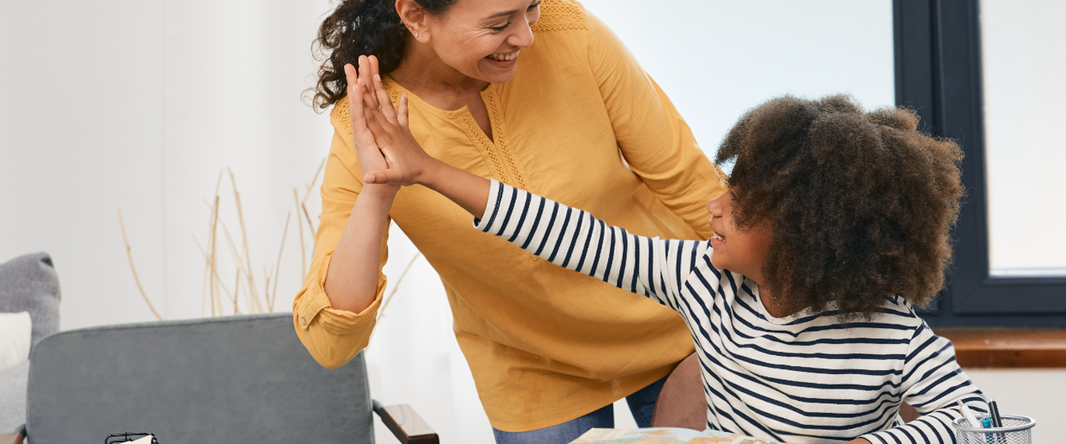 Woman giving high five to child
