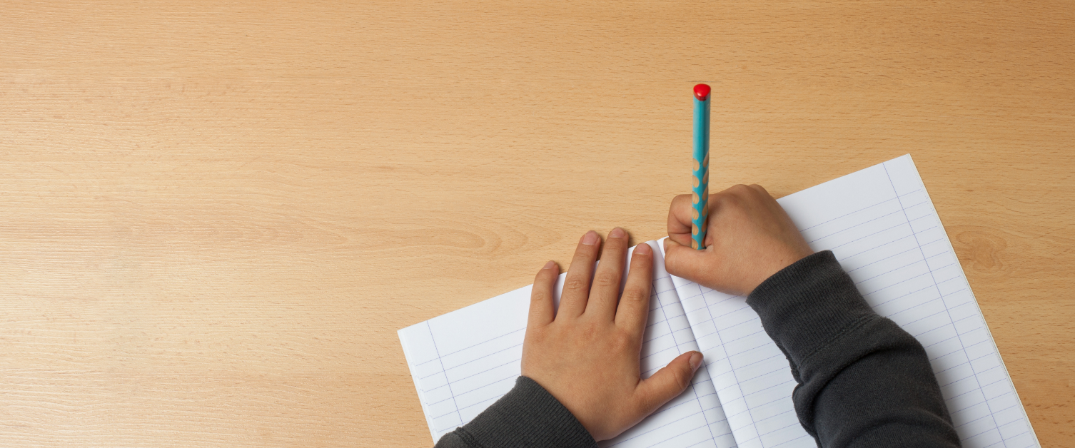 Child writing on paper