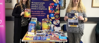 Two members of staff promoting Carers Week