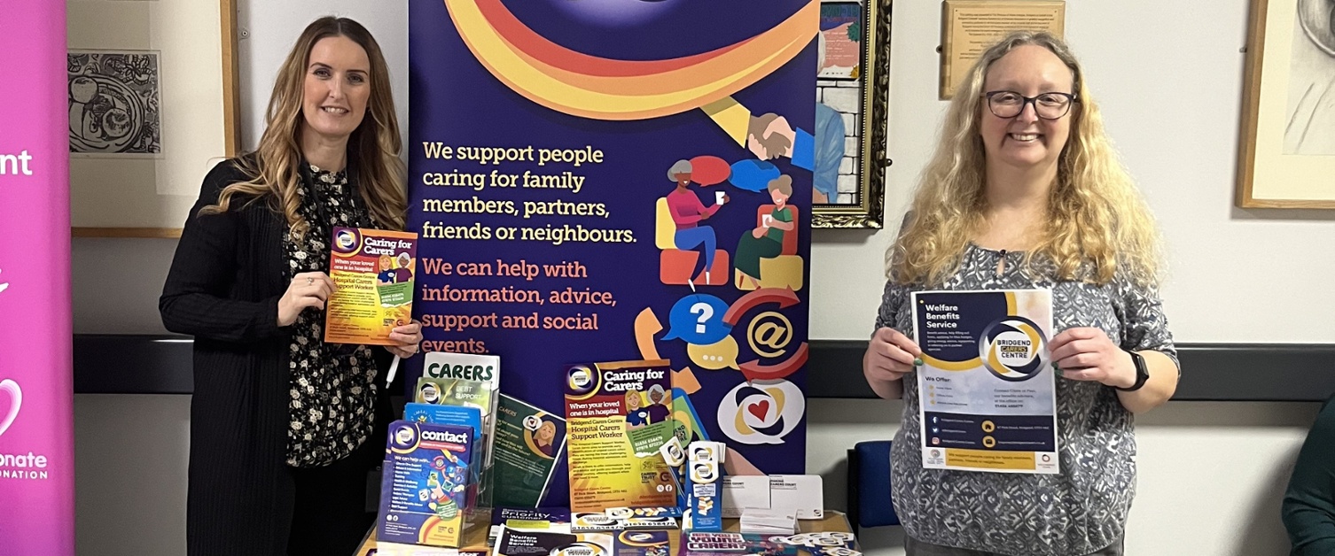 Two members of staff promoting Carers Week