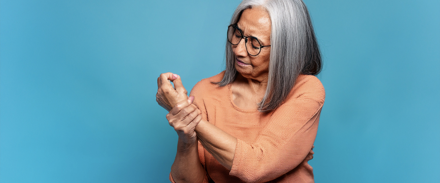elderly woman holding wrist