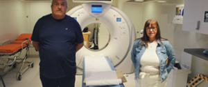Two CTM UHB patients standing next to Lung Health Check scanner