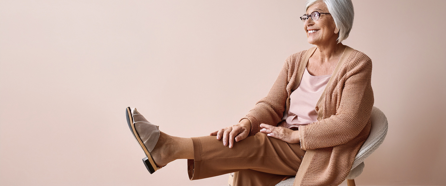 elderly woman sat on a chair doing exercises