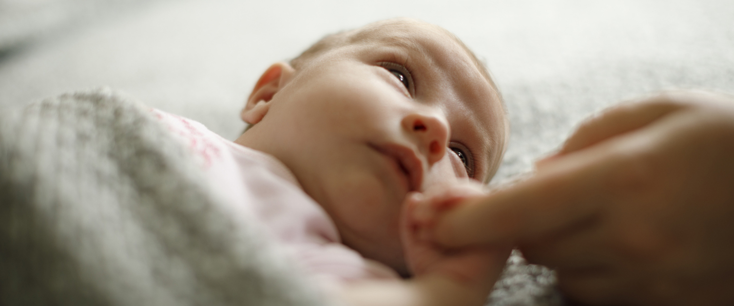 baby holding a finger