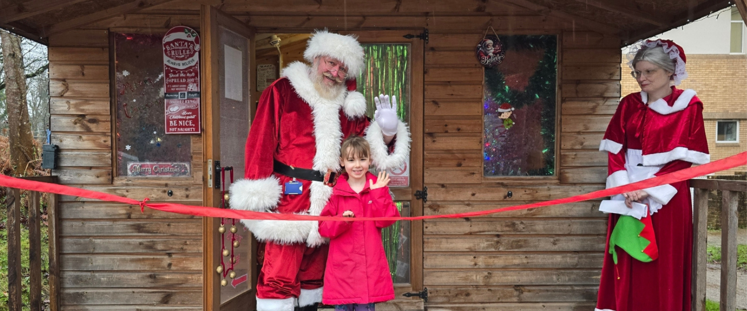 Hollie cutting the ribbon to officially open the grotto with Santa. 