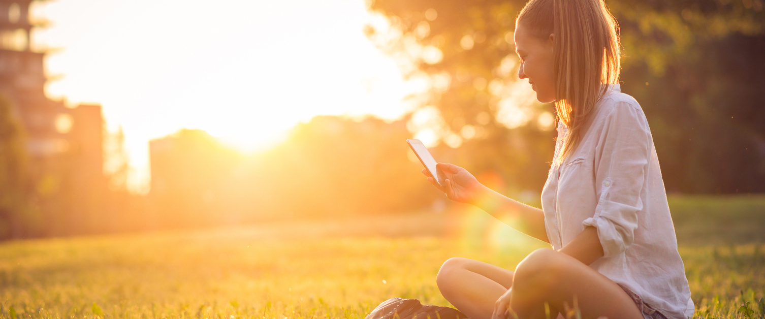 woman on phone sat in the sun