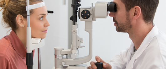 Optometrist performing eye health check