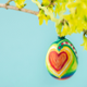 painted egg on a branch