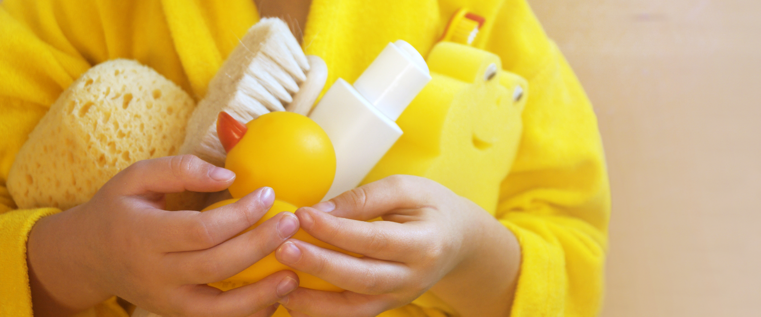 Child holding bath items