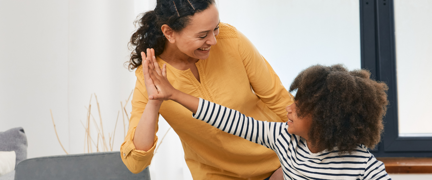 Child high fiving his parent
