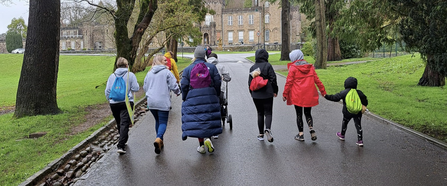 people walking through park