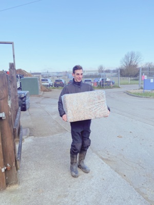 Man holding slab of cardboard