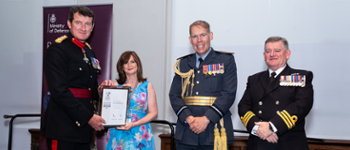 Karen Wright, receiving the ERS Silver Award from Brigadier Nick Thomas CBE; Commander Steve Henaghen, Chief of Staff, Deputy Naval Regional Wales and Western England and Air Officer Wales, and Air Commodore Rob Wood OBE.