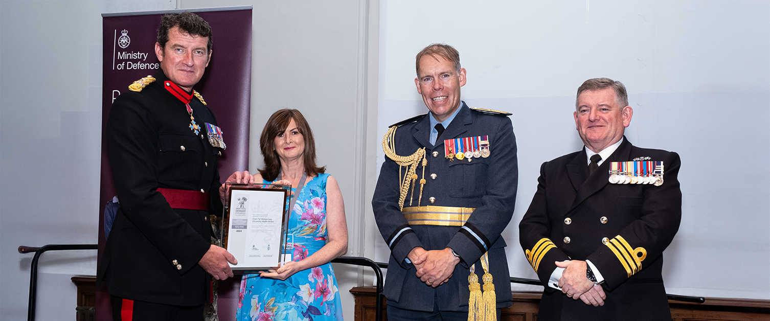 Karen Wright, receiving the ERS Silver Award from Brigadier Nick Thomas CBE; Commander Steve Henaghen, Chief of Staff, Deputy Naval Regional Wales and Western England and Air Officer Wales, and Air Commodore Rob Wood OBE.