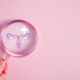 Magnifying glass looking at cervical icon