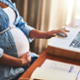 Pregnant woman using a laptop