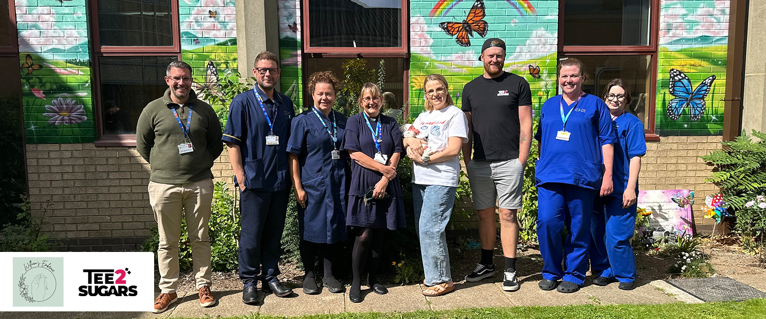 Staff and Tee2Sugars standing by Graffiti Mural in Butterfly Memorial Garden