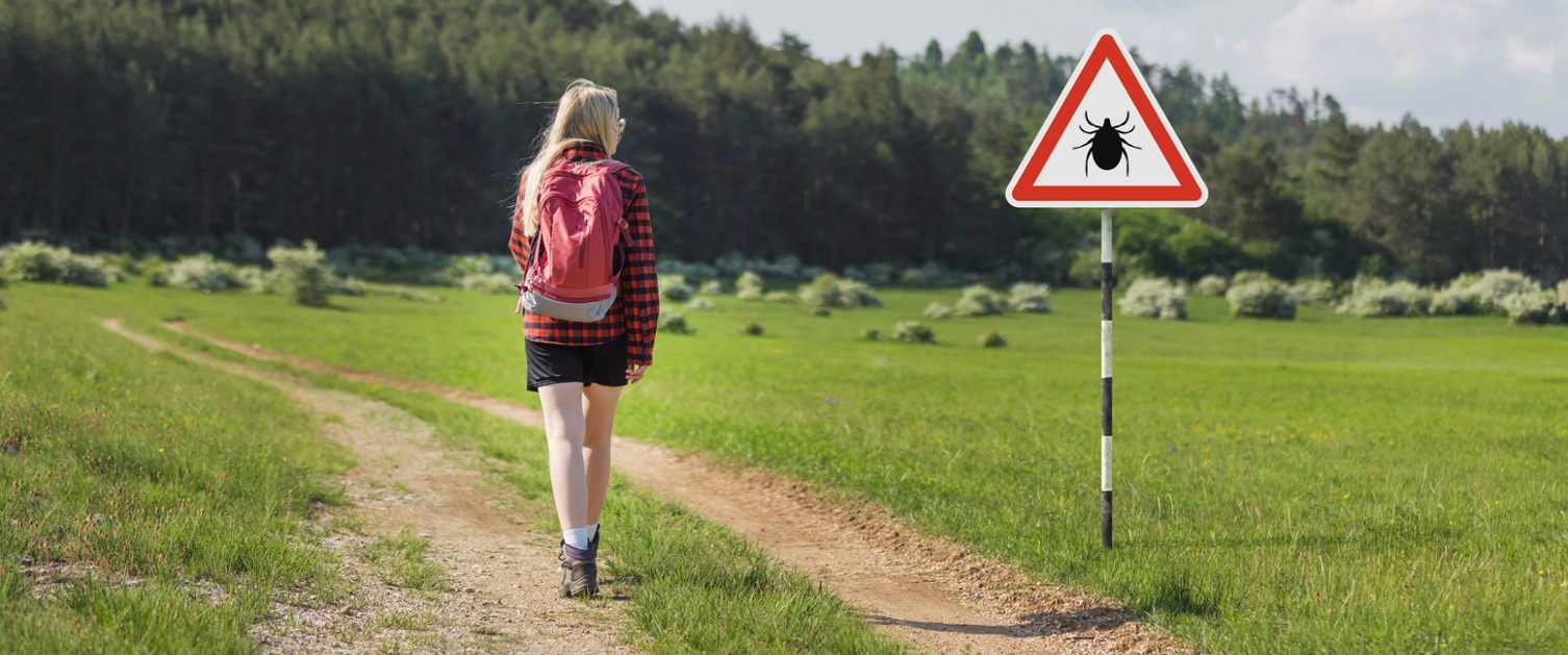 woman walking with a bug warning sign